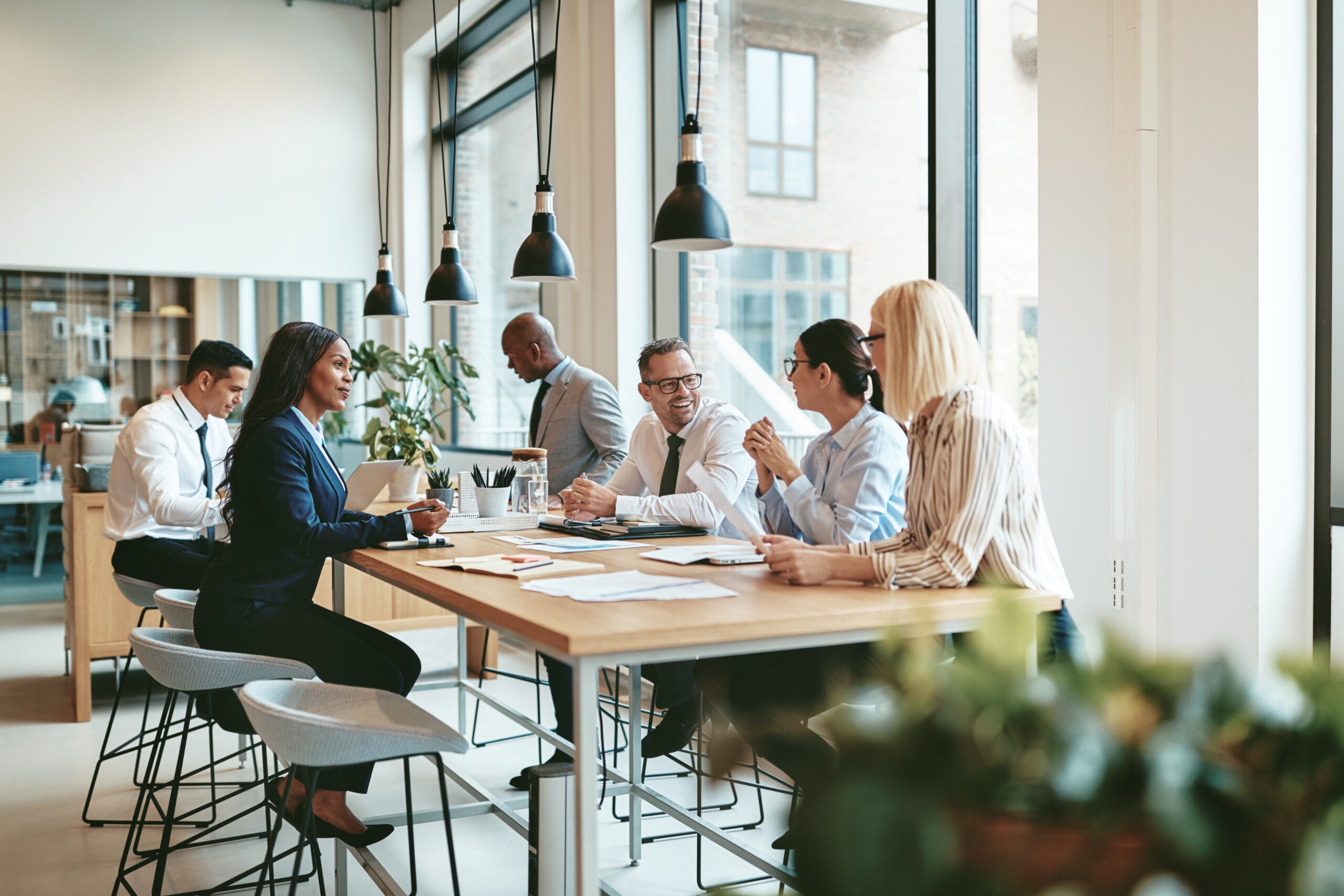 Smiling group of diverse businesspeople discussing paperwork