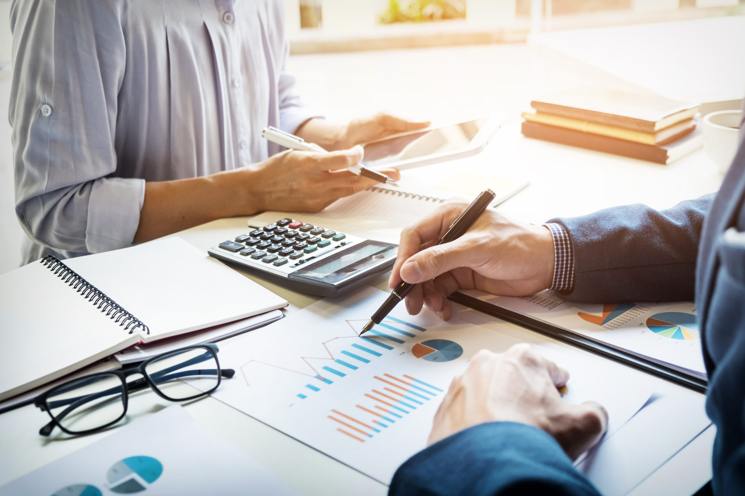 business man financial inspector and secretary making report, calculating or checking balance.